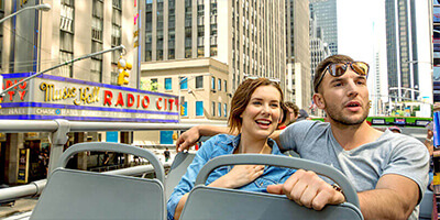 a Young Couple Sitting on a Double Decker Bus