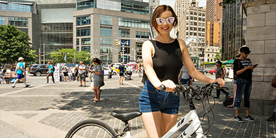 a Young Female holding a bike